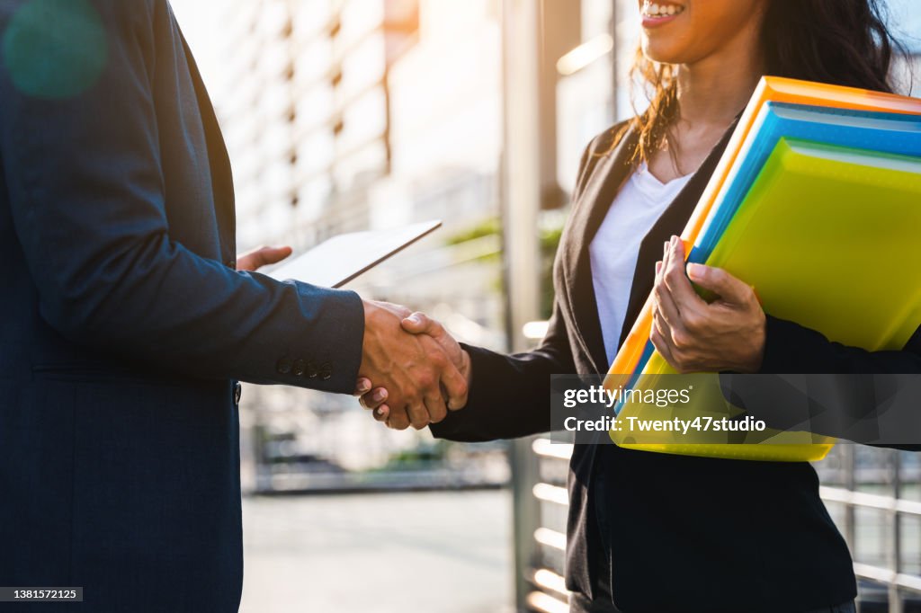 Colleagues doing hand shake greeting