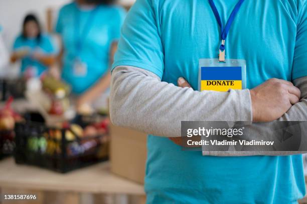 close-up of a food band volunteer helping the people in need in ukraine. - ukraine war stock pictures, royalty-free photos & images