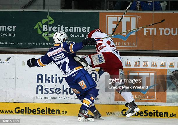 Brian Roloff of Augsburg Panther is hit hard by Ulrich Maurer during the DEL match between EHC Muenchen and Augsburger Panther on February 3, 2012 in...