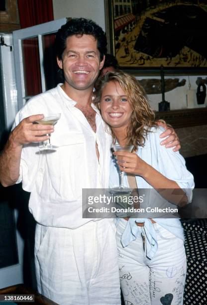 Actor Micky Dolenz and his daughter Ami Dolenz lift a glass in good spirits as they pose in 1987 in Los Angeles, California.