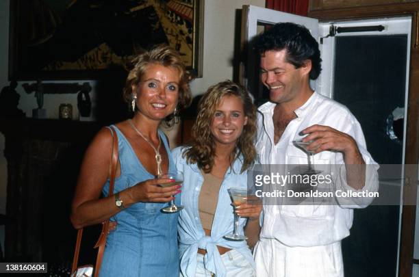 Show business family Samantha Juste Dolenz, Micky Dolenz and their daughter Ami Dolenz lift a glass in good spirits as they pose in 1987 in Los...