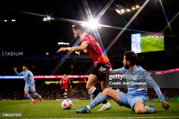 Bruno Fernandes of Manchester United in action with Bernado Silva of Manchester United during the Premier League match between Manchester City and...