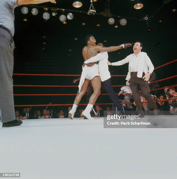 World Heavyweight Title: Cassius Clay victorious with Drew Bundini Brown and trainer Angelo Dundee after 7th round knock out at Convention Hall,...