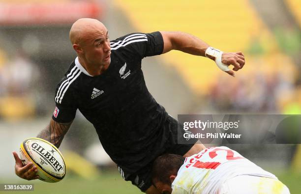 Forbes of New Zealand offloads in the tackle of Jean Baptiste Belanger of France during the match between New Zealand and France on day two of the...