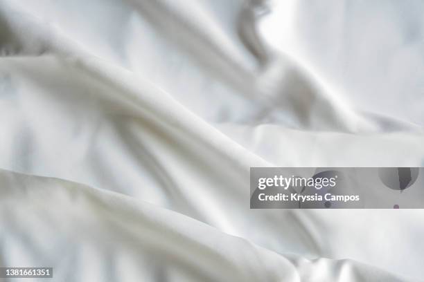 white satin texture background. detail of luxury fabric surface. - silk ストックフォトと画像