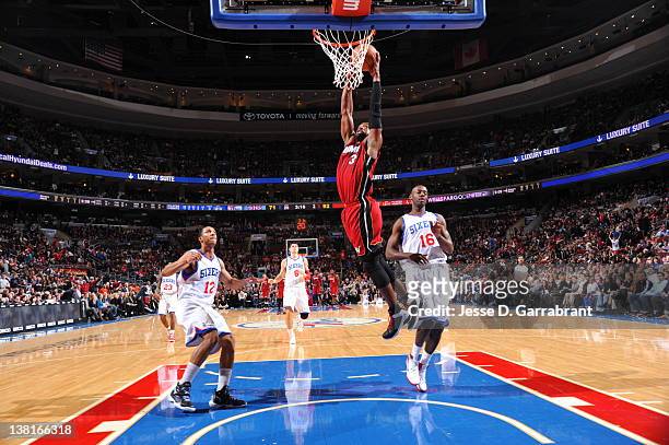 Dwyane Wade of the Miami Heat dunks against Evan Turner and Francisco Elson of the Philadelphia 76ers on February 3, 2012 at the Wells Fargo Center...