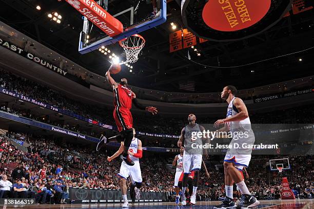 Dwyane Wade of the Miami Heat dunks against Evan Turner and Francisco Elson of the Philadelphia 76ers on February 3, 2012 at the Wells Fargo Center...