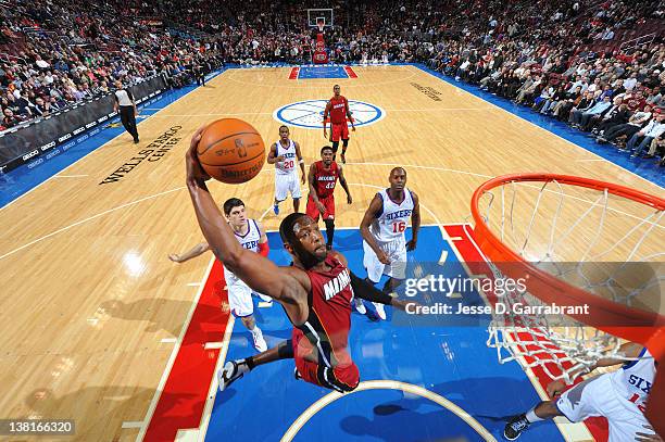 Dwyane Wade of the Miami Heat dunks against Evan Turner and Francisco Elson of the Philadelphia 76ers on February 3, 2012 at the Wells Fargo Center...