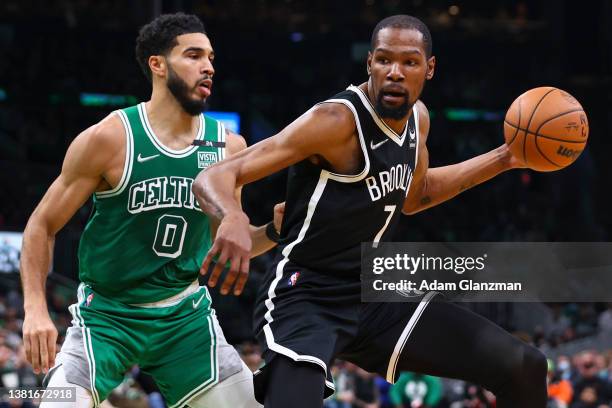 Kevin Durant of the Brooklyn Nets drives to the basket past Jayson Tatum of the Boston Celtics during a game at TD Garden on March 6, 2022 in Boston,...