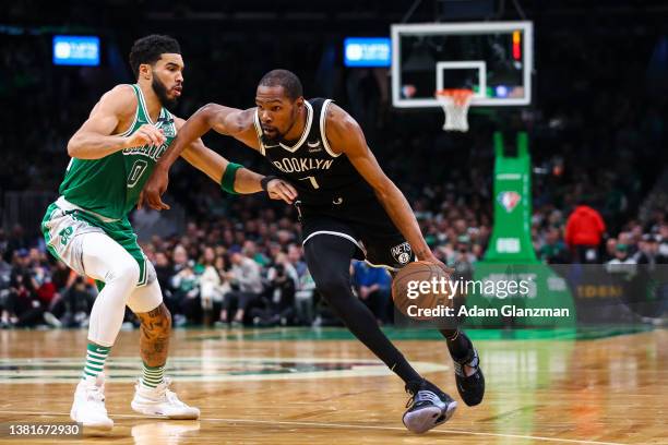 Kevin Durant of the Brooklyn Nets drives to the basket past Jayson Tatum of the Boston Celtics during a game at TD Garden on March 6, 2022 in Boston,...