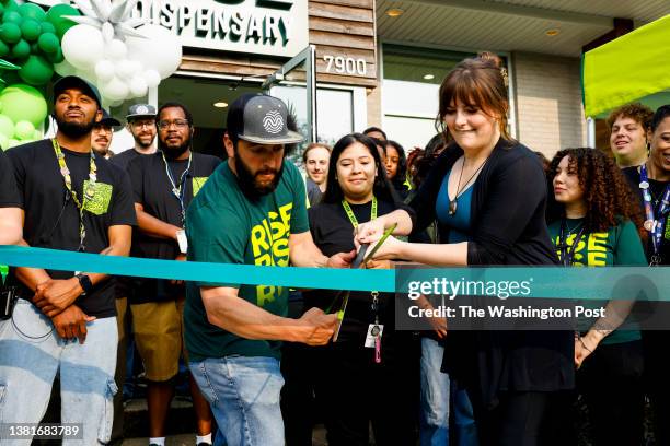 Ben Kovler, CEO of Rise dispensaries and Emma Cannon, from I Support the Gils, cut a ribbon to open the Rise dispensary in Silver Spring, MD on July...