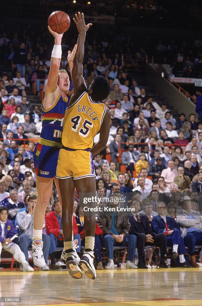 Tim Kempton Magic Tim Kempton of the Denver Nuggets shoots a jump shot over A.C. Green ...