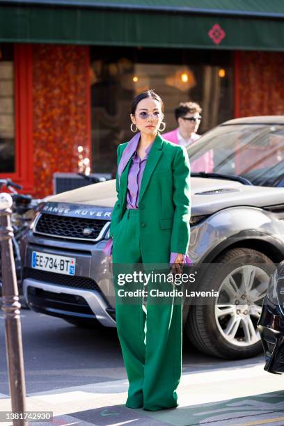 Yoyo Cao wearing a green suit and purple shirt, is seen outside Valentino, during Paris Fashion Week - Womenswear F/W 2022-2023 on March 06, 2022 in...