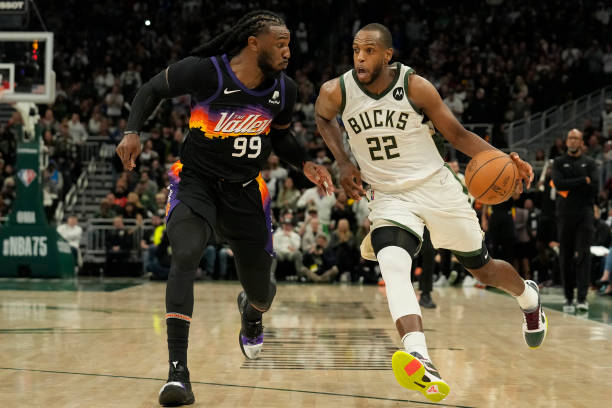 Khris Middleton of the Milwaukee Bucks dribbles the ball against Jae Crowder of the Phoenix Suns during the second half at Fiserv Forum on March 06,...