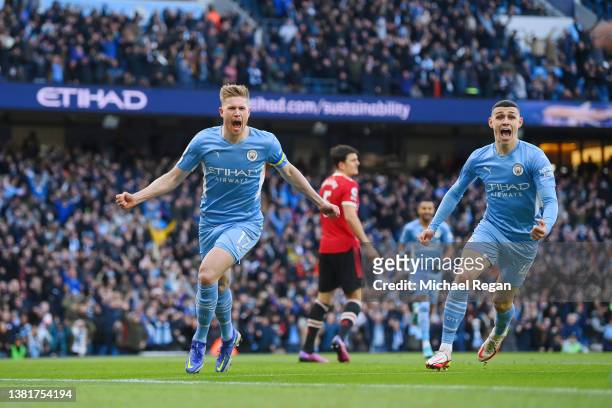 Kevin De Bruyne of Manchester City celebrates with team mate Phil Foden after scoring their sides first goal during the Premier League match between...