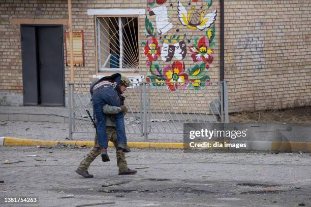 Ukrainian soldier aids a victim of a mortar attacks from Russian forces on March 6, 2022 in Irpin, Ukraine. At least four died in the attack....
