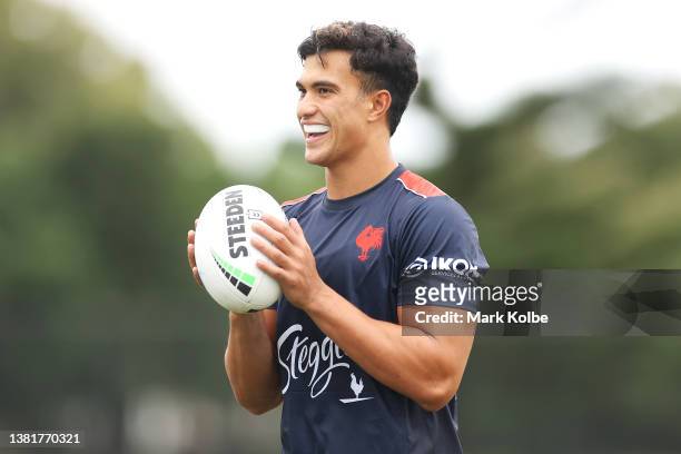 Joseph Suaalii shares a laugh with a team mate during a Sydney Roosters NRL training session at Robertson Road Synthetic Field on March 07, 2022 in...