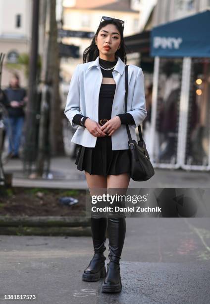 Cindy is seen wearing a white jacket, black top, black skirt, black boots, black bag and a Dior belt with black sunglasses outside the Valentino show...