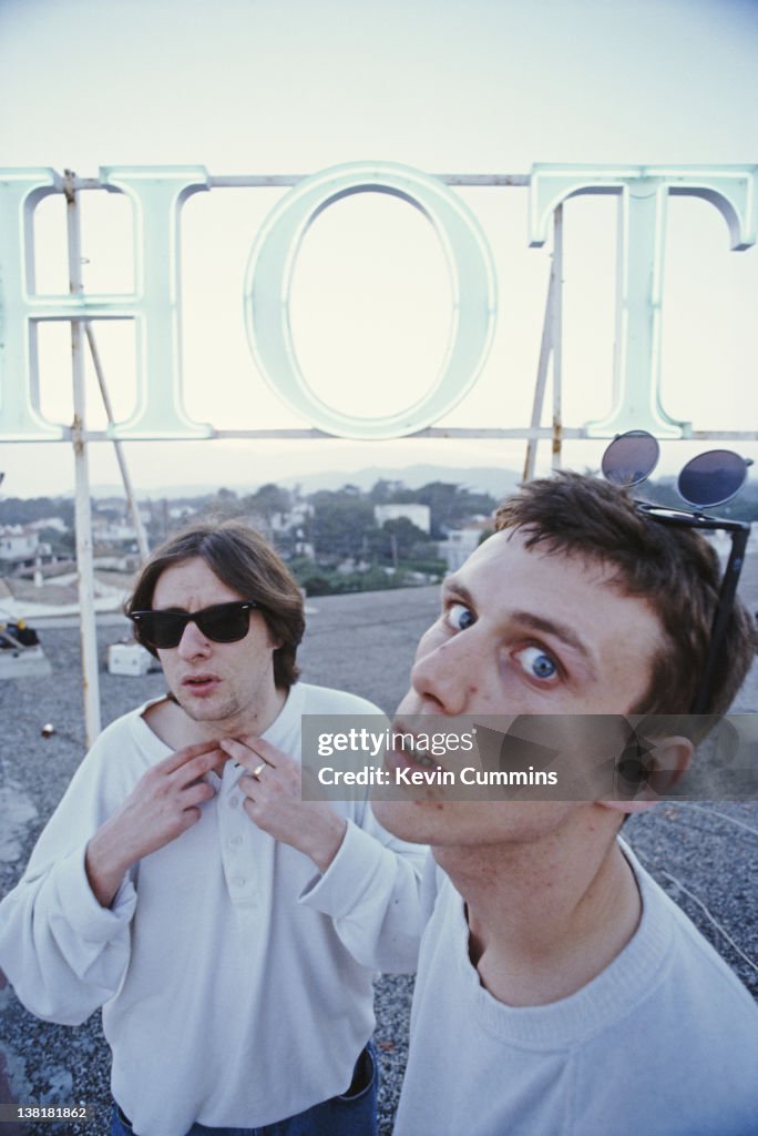 Bez Singer Singer Shaun Ryder and dancer Bez of the Happy Mondays, by a sign on ...