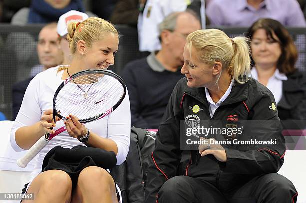 Sabine Lisicki of Germany jokes with teamcaptain Barbara Rittner prior to her single match against Iveta Benesova of Czech Republic during day one of...