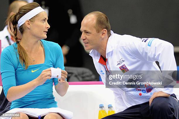 Iveta Benesova of Czech Republic talks to teamcaptain Petr Pala prior to her single match against Iveta Benesova of Czech Republic during day one of...