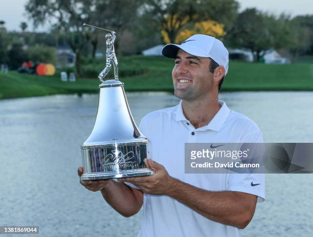 Scottie Scheffler of The United States looks at Arnold Palmer's figurine on the trophy after his one stroke win in the final round of the Arnold...