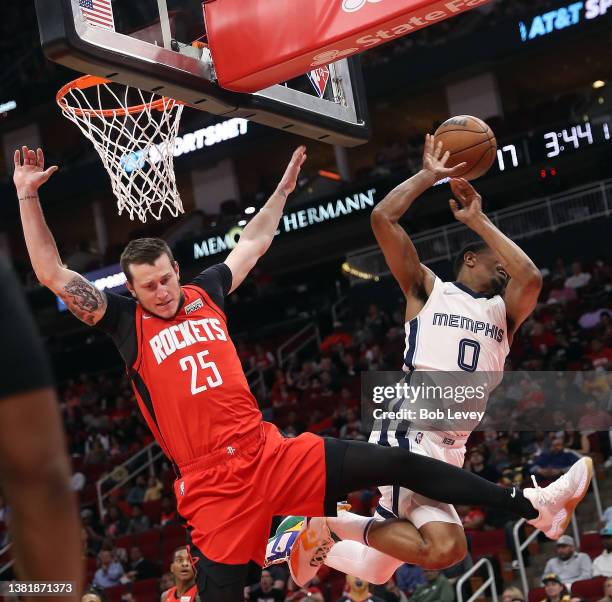 De'Anthony Melton of the Memphis Grizzlies is fouled by Garrison Mathews of the Houston Rockets as he drives to the basket during the second quarter...