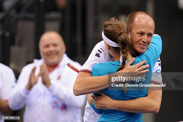 Iveta Benesova of Czech Republic celebrates with teamcaptain Petr Pala after winning her single match against Sabine Lisicki of Germany during day...