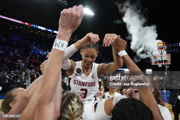 The Stanford Cardinal hoist Anna Wilson after their victory over the Utah Utes in the championship game of the Pac-12 Conference women's basketball...