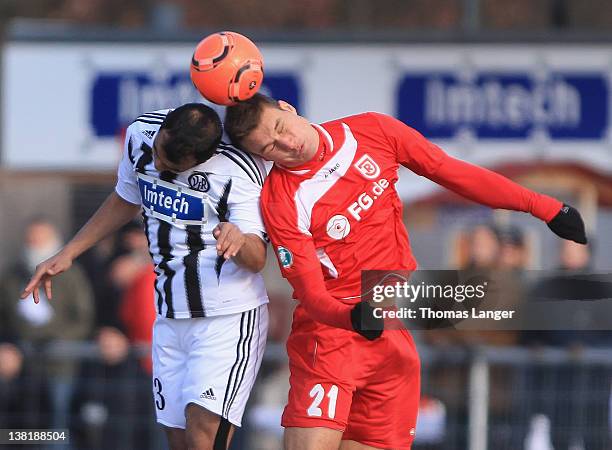 Andreas Hofmann of Aalen and Thomas Kurz of Regensburg battle for the ball during the Third League match between VfR Aalen and Jahn Regensburg at the...