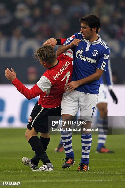 Raul Gonzalez of Schalke knocks down Eugen Polanski of Mainz during the Bundesliga match between FC Schalke 04 and FSV Mainz 05 at Veltins Arena on...