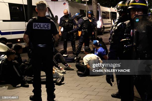 Police personnel detain suspects on a street in Nice, south-eastern France late July 1 during the fifth night of rioting following the shooting of a...