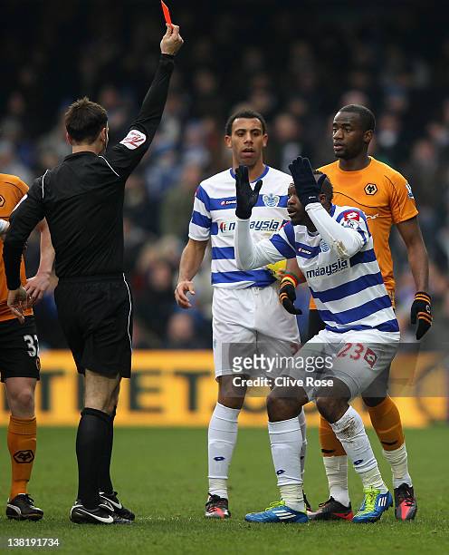 Djibril Cisse of Queens Park Rangers is shown a red card by referee Mark Clattenburg during the Barclays Premier League match between Queens Park...