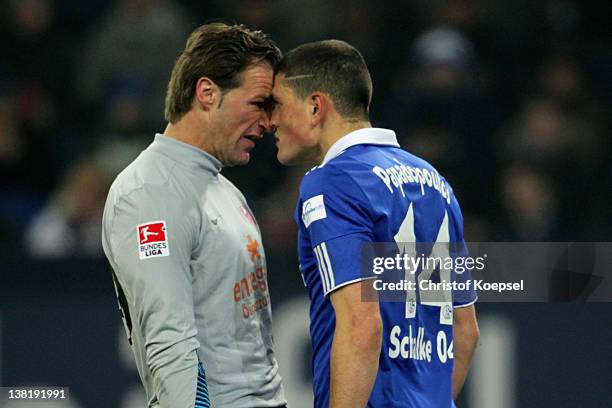 Christian Wetklo of Mainz and Kyriakos Papadopoulos of Schalke knock at each other during the Bundesliga match between FC Schalke 04 and FSV Mainz 05...