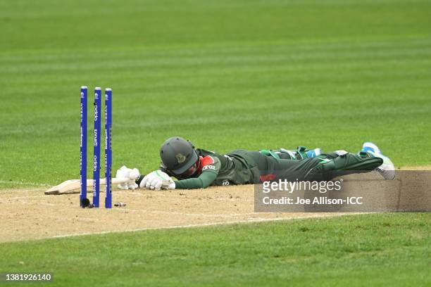 Jahanara Alam of Bangladesh reacts on the ground after being run out by Amy Satterthwaite of New Zealand during the 2022 ICC Women's Cricket World...