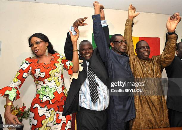 Members of the Senegalese opposition, Diouma Dieng Diakhate, Alioune Tine, Youssou Ndour and Macky Sall raise their hands together during a press...