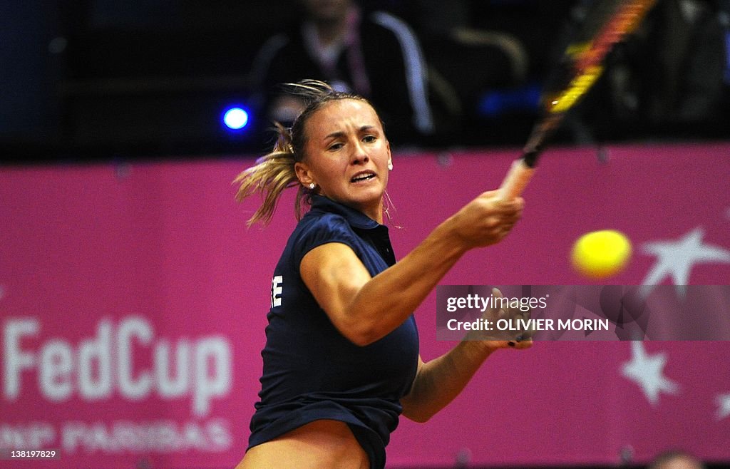 Ukraine's Lesia Tsurenko returns the bal