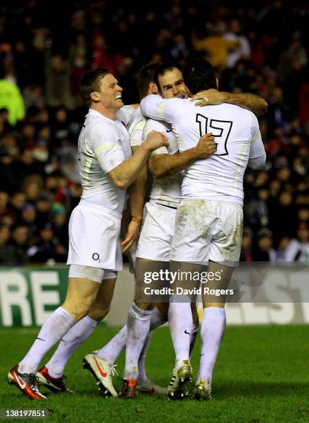 Flyhalf Charlie Hodgson of England is congratulated by teammates after scoring the opening try during the RBS Six Nations match between Scotland and...