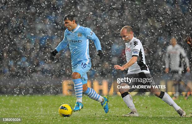 Manchester City's Argentinian striker Sergio Aguero is chased by Fulham's English midfielder Danny Murphy during the English Premier League football...