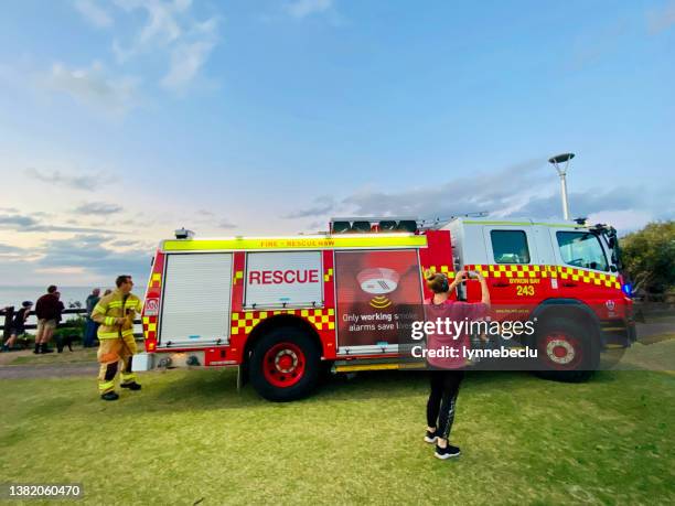 woman photographing fire truck at main beach, byron bay - fire truck australia stock pictures, royalty-free photos & images