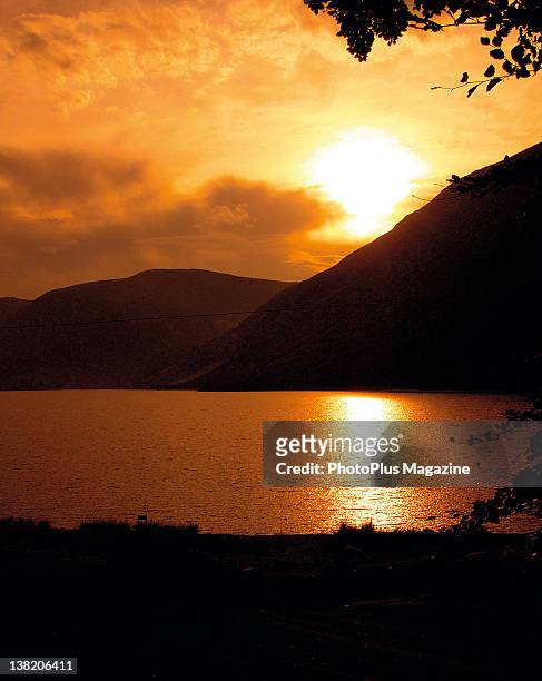 Picturesque sunset over a lake and the surrounding silhouetted hills, taken on August 17, 2010.