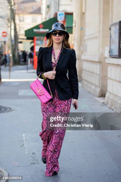 Maria Rosaria Rizzo seen wearing black bucket hat, pink Valentino bag, wide leg pants with floral print, black blazer, wrapped top, sunglasses...