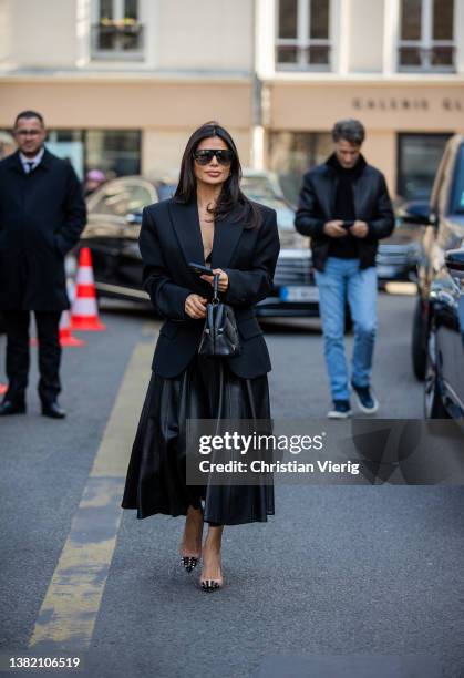 Victoria Barbara seen wearing black blazer tailored, leather skirt, bag, heels outside Valentino during Paris Fashion Week - Womenswear F/W 2022-2023...