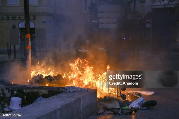 View of a burning shopping cart next to the garbage as people gather to protest against the death of 17-year-old Nahel, who was shot in the chest by...
