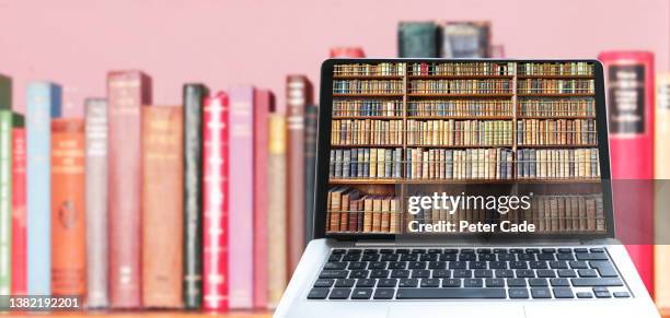laptop computer with books on screen - library database stock pictures, royalty-free photos & images