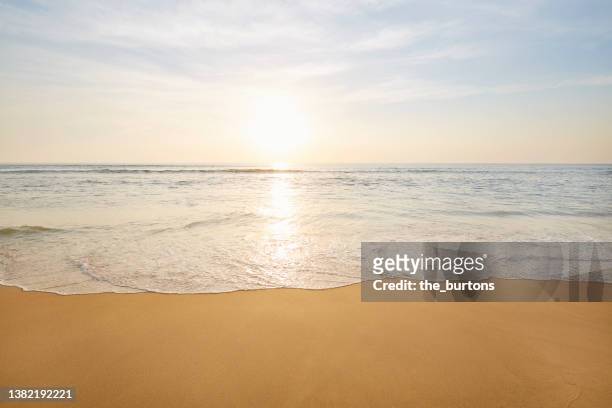 beach, sea and sky at idyllic sunset - rive photos et images de collection