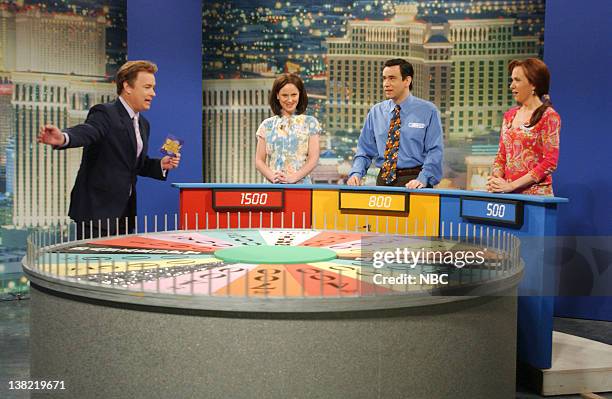 Episode 17 -- Aired -- Pictured: Tom Hanks as Pat Sajak, Amy Poehler as Donna, Fred Armisen as Kenny, Kristen Wiig as Marjorie during "Wheel of...