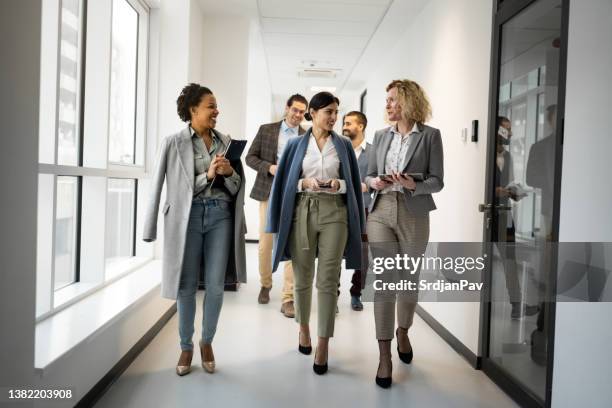 multiracial business people heading to the meeting - coming home stock pictures, royalty-free photos & images