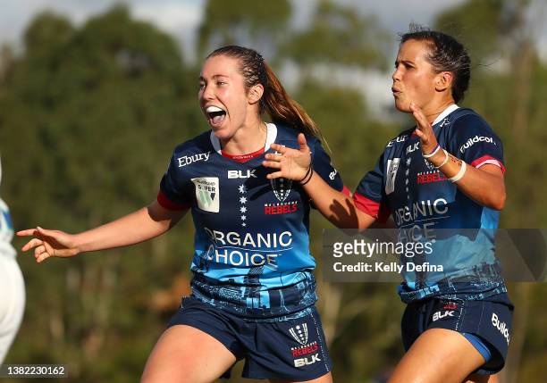 Meretiana Robinson of the Rebels celebrates scoring a try with Annie Buntine of the Rebels during the round one Super W match between the Melbourne...