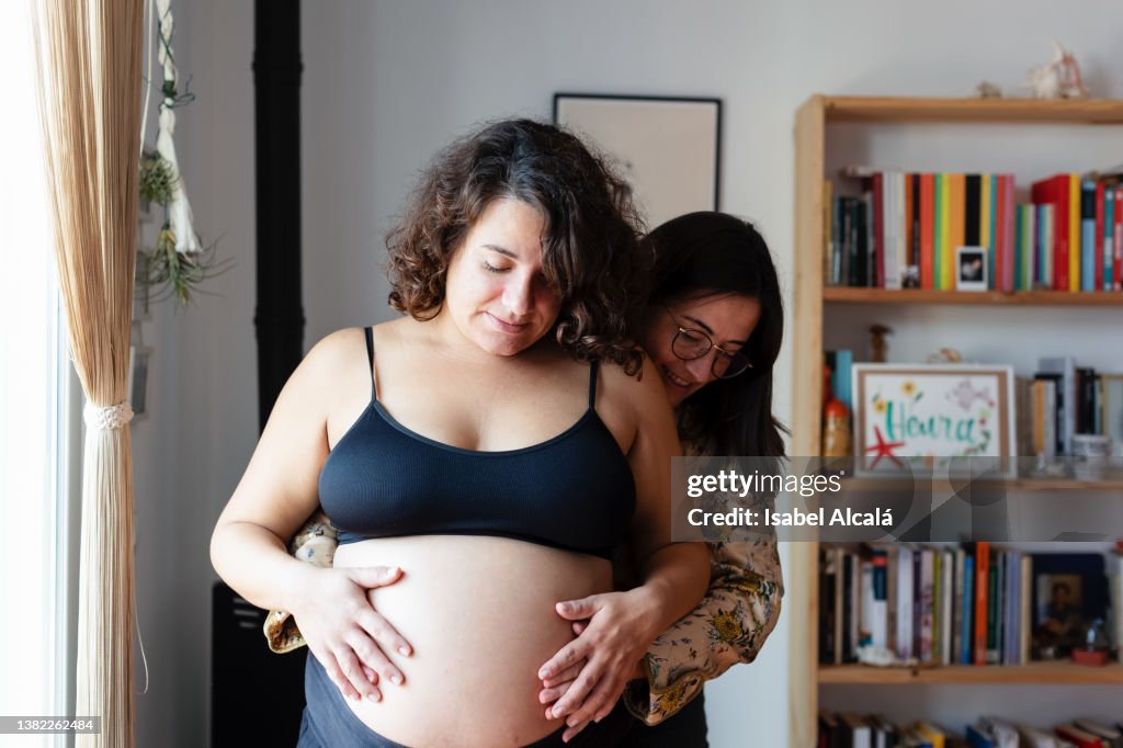 Young pregnant female couple